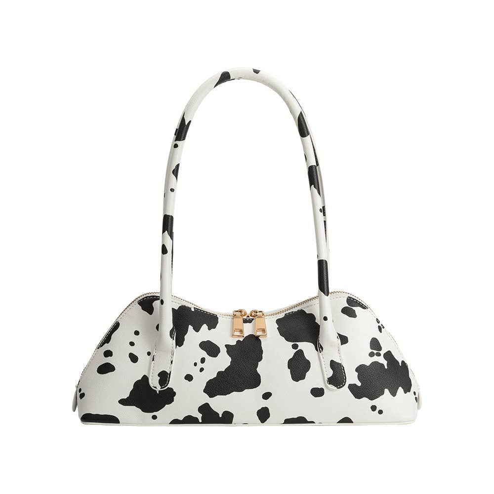 White handbag with black cow print pattern on a white background