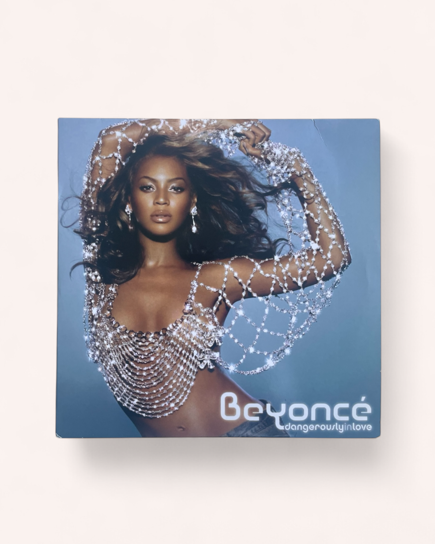 Album cover featuring a person in a sparkling outfit with 'Beyoncé' branding on a blue background. Dangerously in Love Vinyl Record - Beyonce