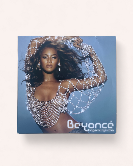 Album cover featuring a person in a sparkling outfit with 'Beyoncé' branding on a blue background. Dangerously in Love Vinyl Record - Beyonce