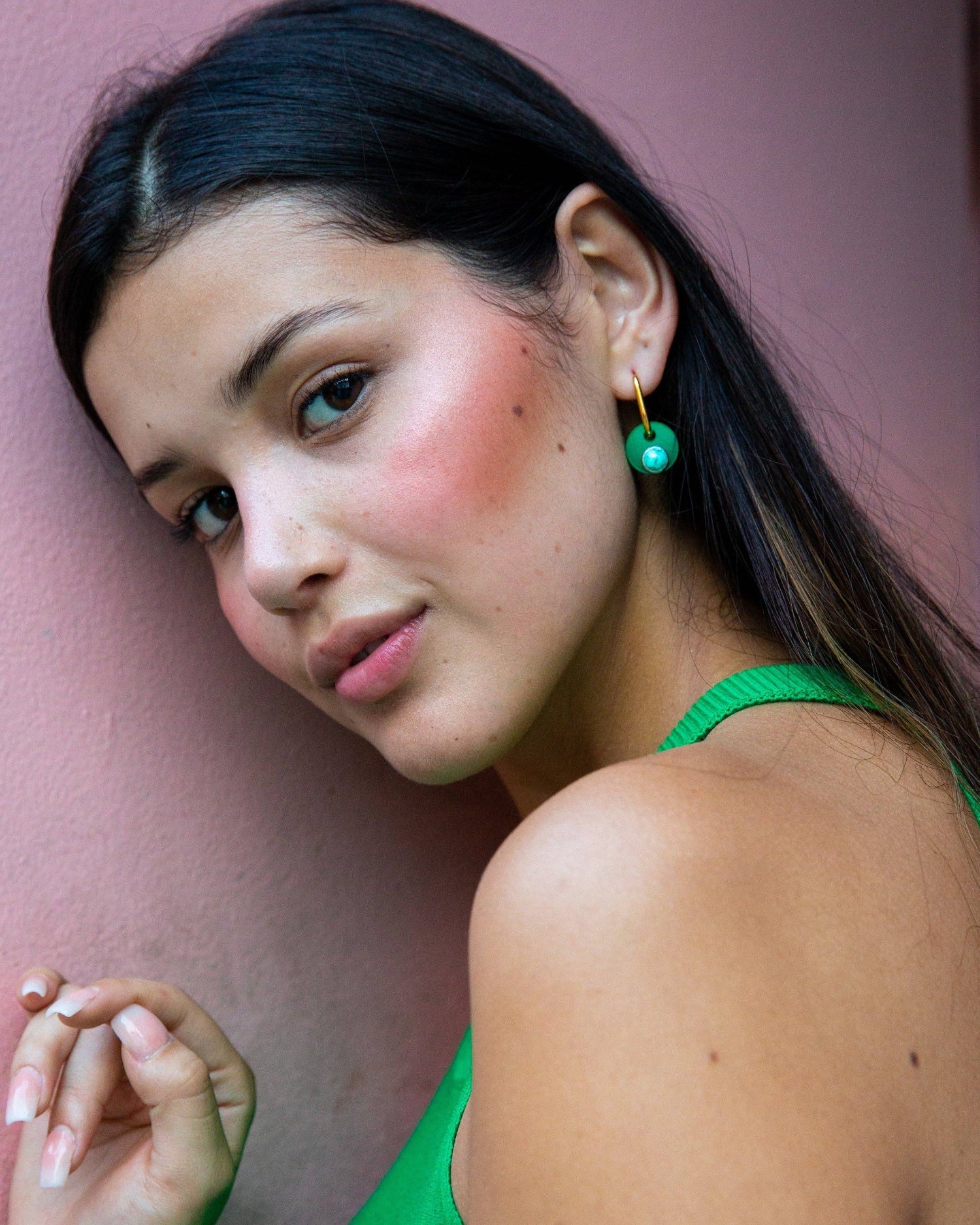 Woman wearing green earrings against a pink wall, Deco Glam Hoop Earrings