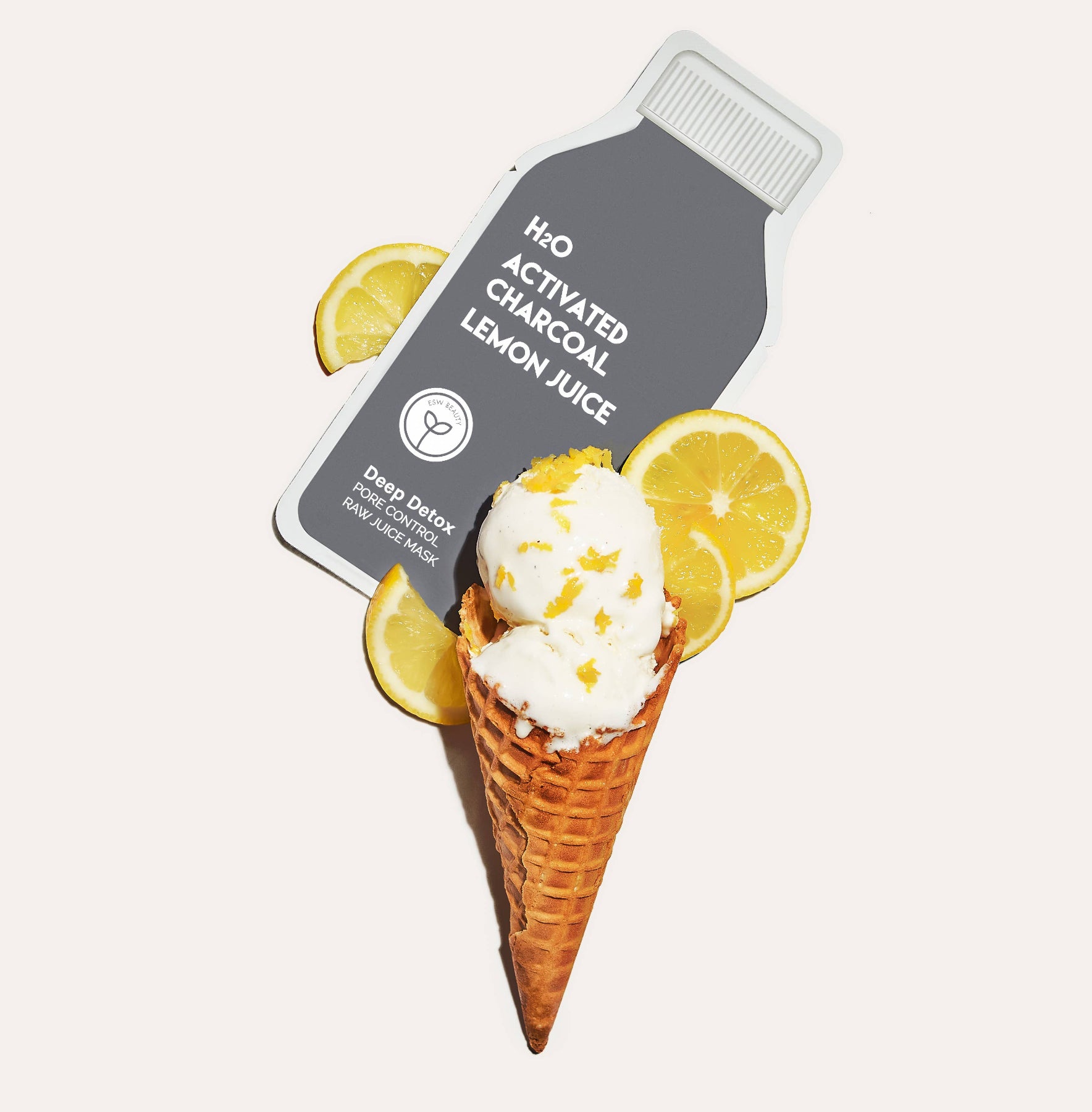 Product packaging labeled 'H2O Activated Charcoal Lemon Juice' with a cone of ice cream and lemon slices on a white background.