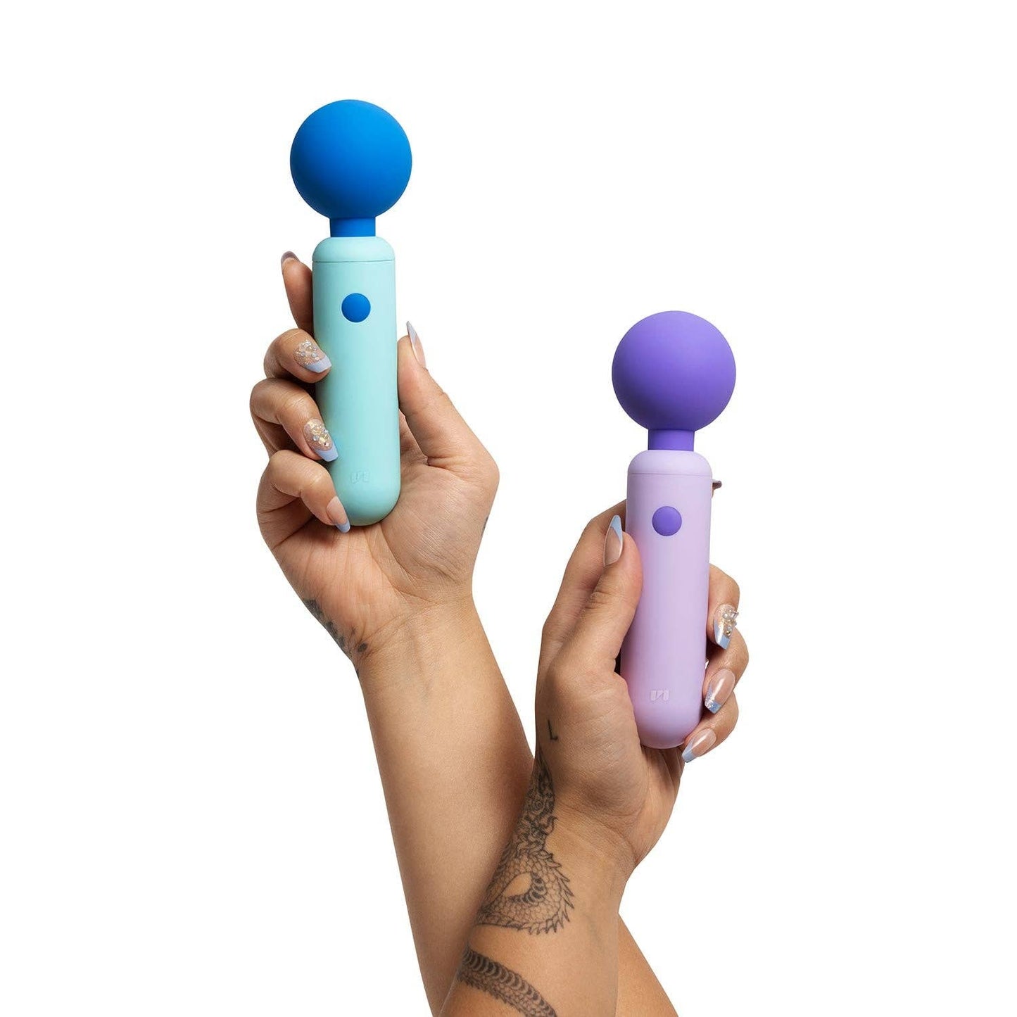 Two handheld massagers, one blue and one purple, held in hands against a white background.