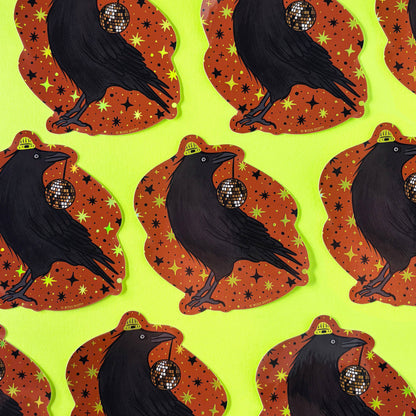 Pattern of black crows with disco balls on orange backgrounds against a green background