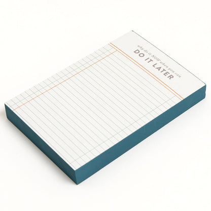 Notebook with grid paper and 'Do It Later' text on a white background