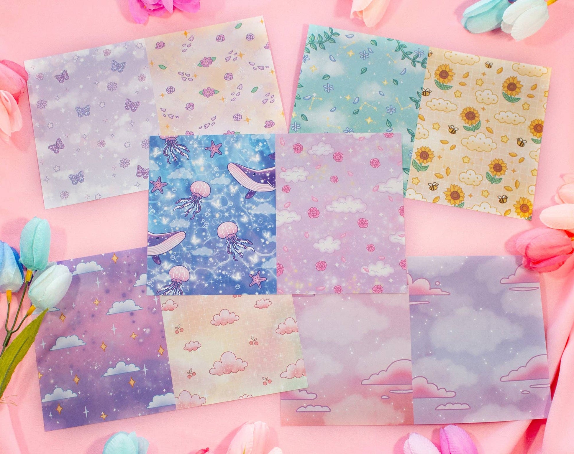 Set of colorful stationery sheets with various patterns on a pink background
