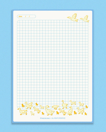 Grid paper with decorative duck illustrations on a blue background