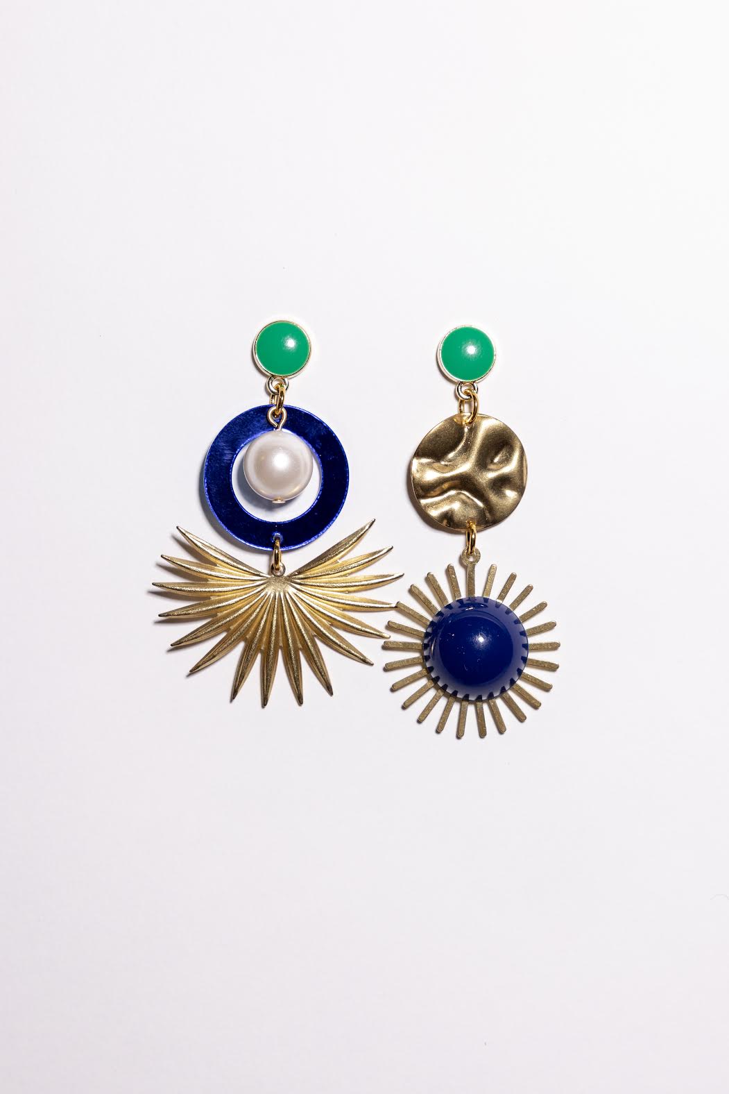 Pair of earrings with blue, gold, and green elements on a white background
