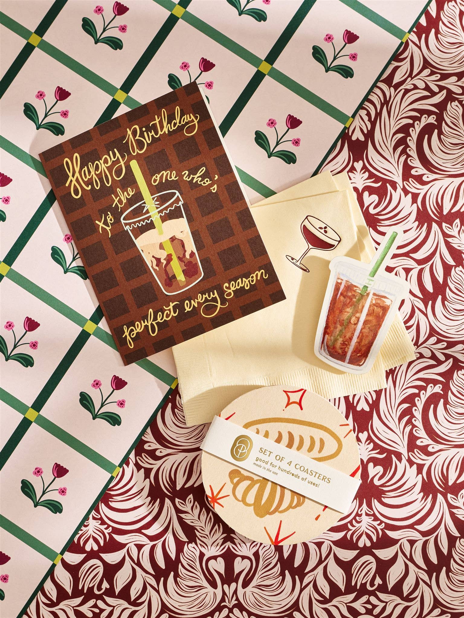 Set of four coasters with a design of a drink and text on a patterned surface