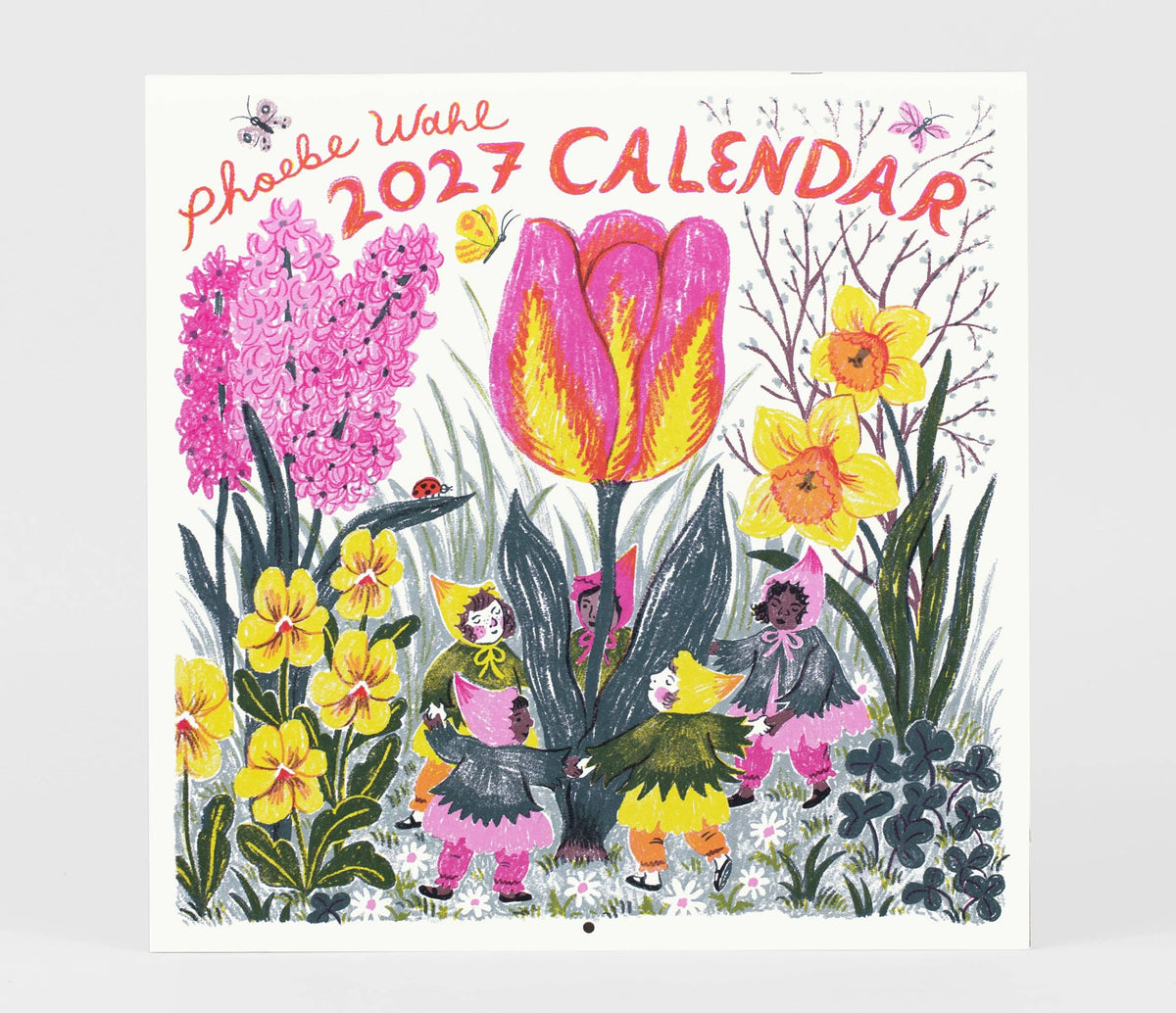 Phoebe Wahl 2027 Calendar featuring a whimsical spring garden illustration with a large pink and yellow tulip, daffodils, hyacinths, and small children in colorful outfits, shown against a light gray background.