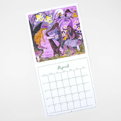A single-page desk calendar with a whimsical purple-toned illustration on the cover and a printed April calendar grid on the page, photographed on a white background.