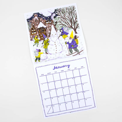 A two-sided desk calendar page shown on a light gray background. The top page features a whimsical winter illustration with a snowman, children in colorful hats and jackets, a house, and bare trees.