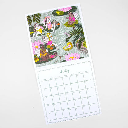A single-page desk calendar or print with a whimsical illustrated pond scene on the top half and a July calendar grid on the bottom half, photographed on a clean white background.