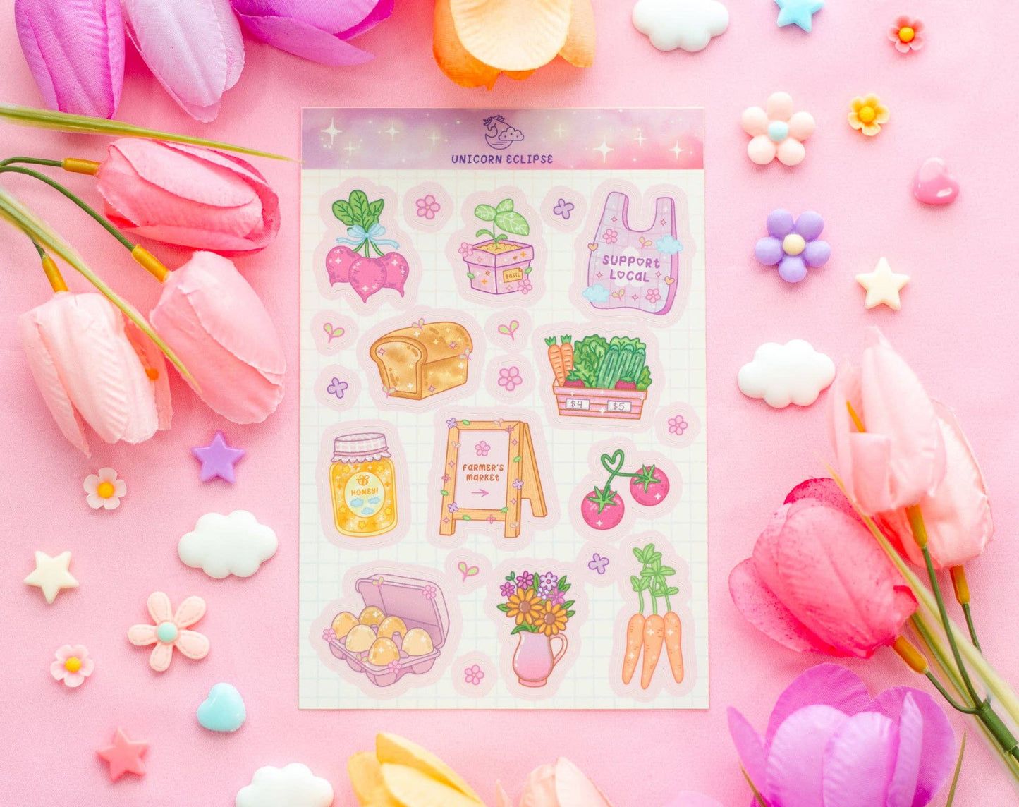 Sheet of colorful stickers on a pink background with flowers and decorative items.