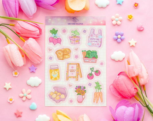 Sheet of colorful stickers on a pink background with flowers and decorative items.