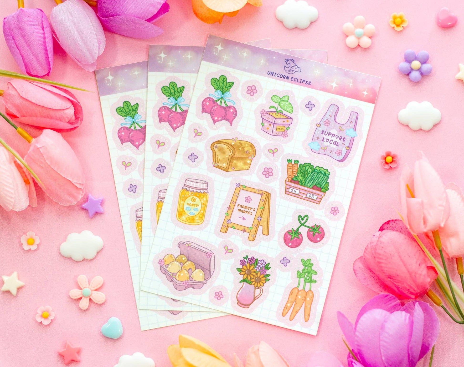Sticker sheets with cute illustrations on a pink background with flowers and toys.
