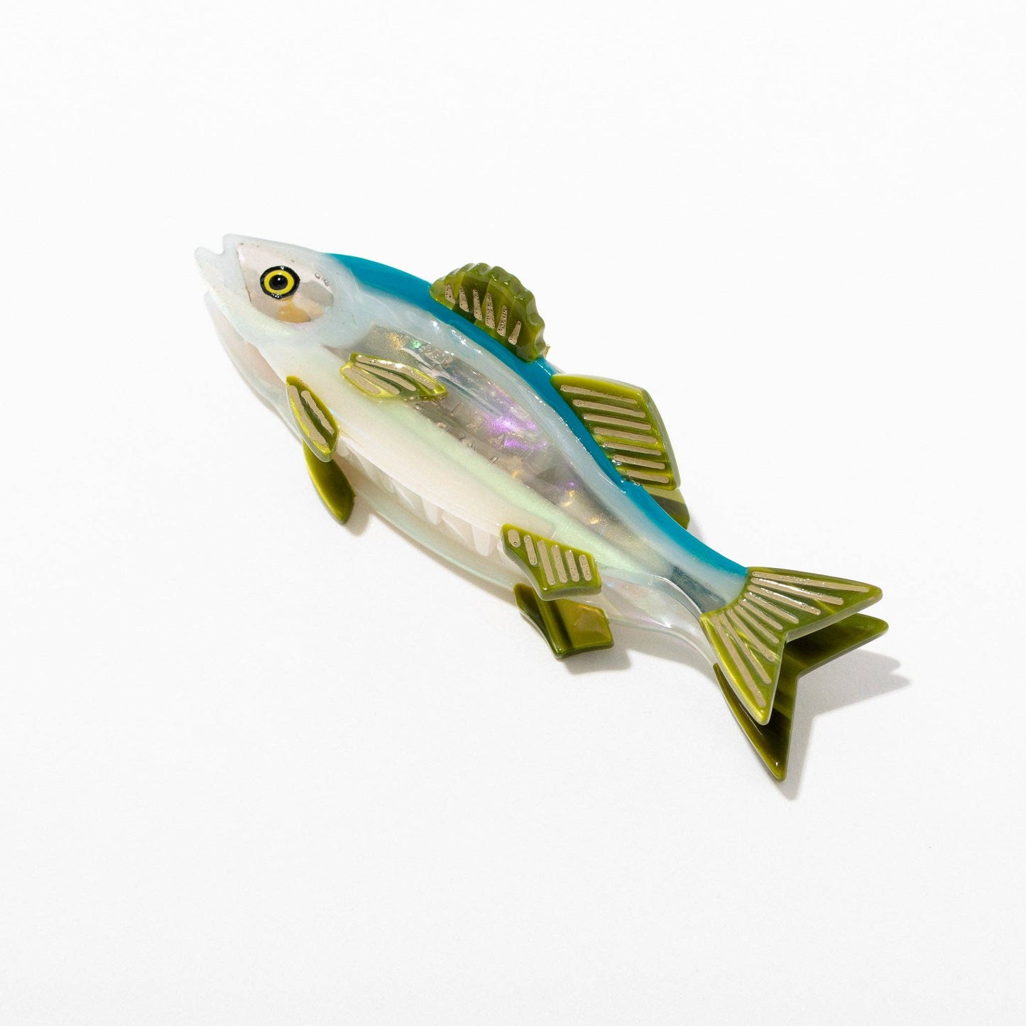Toy fish with a white body, blue back, and green fins on a white background