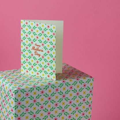 Floral Mother's Day card on a matching floral box with a pink background