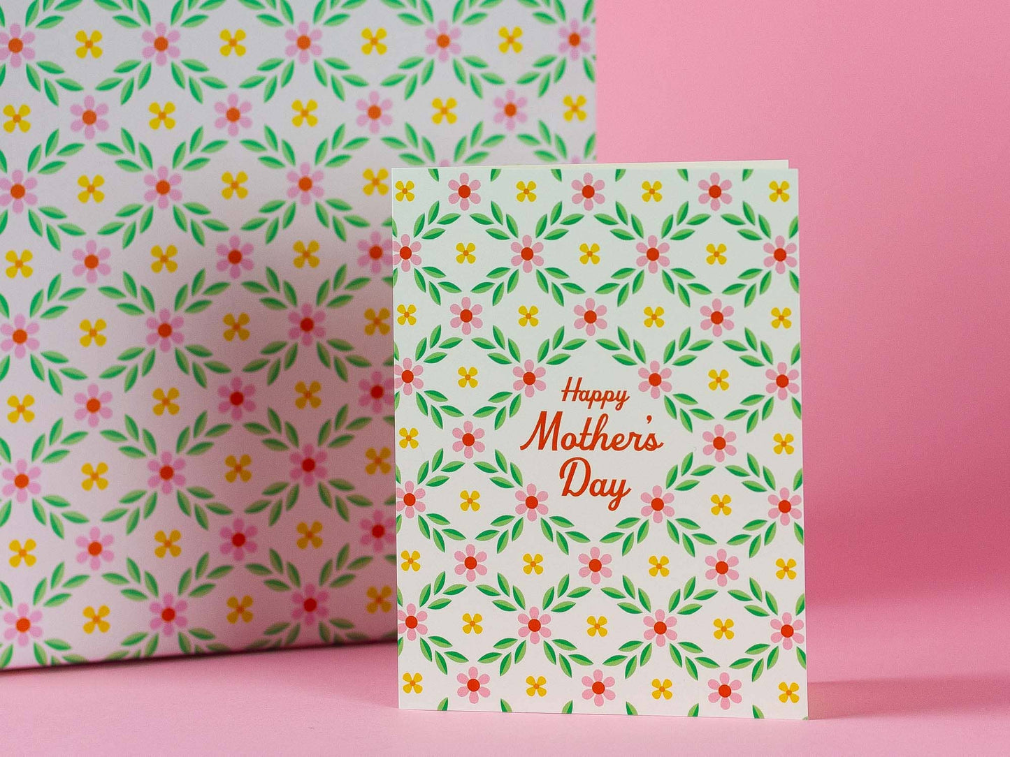 Floral-patterned card with 'Happy Mother's Day' text on a pink background