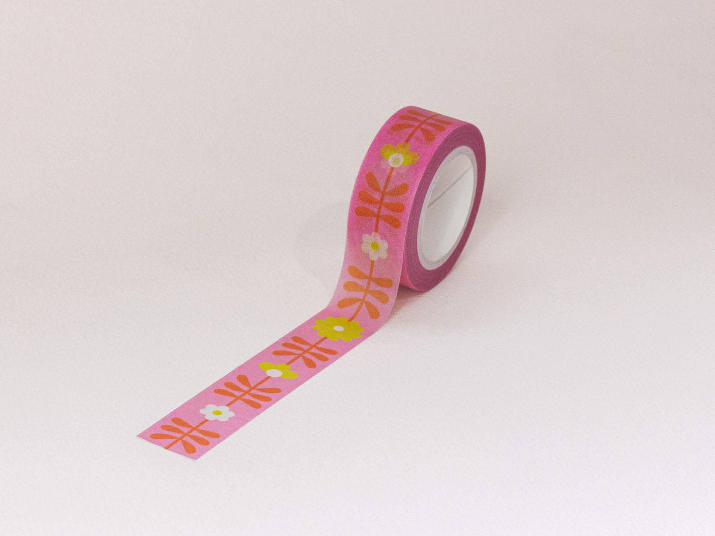 Roll of decorative tape with floral pattern on a white background