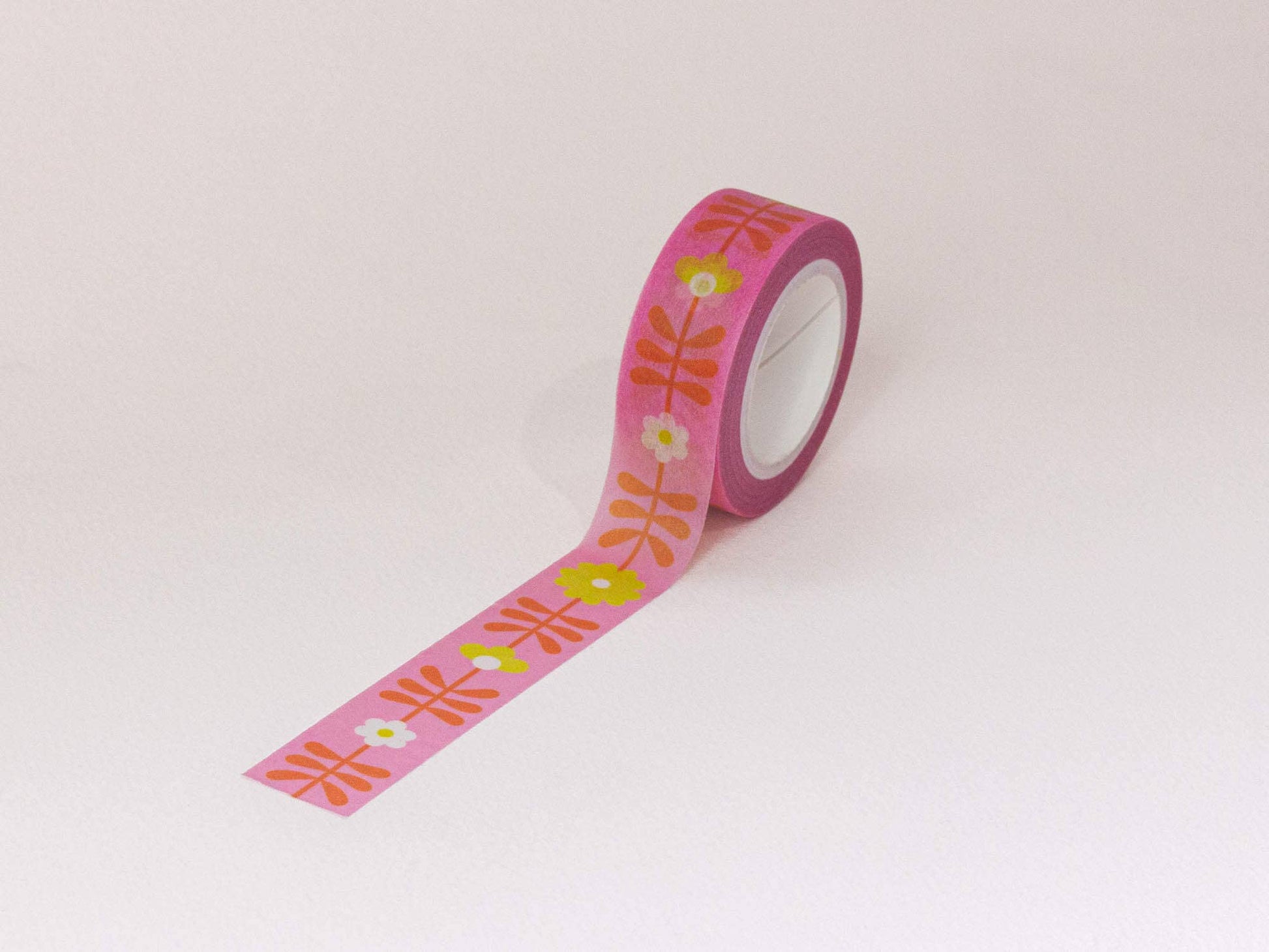 Roll of decorative tape with floral pattern on a white background