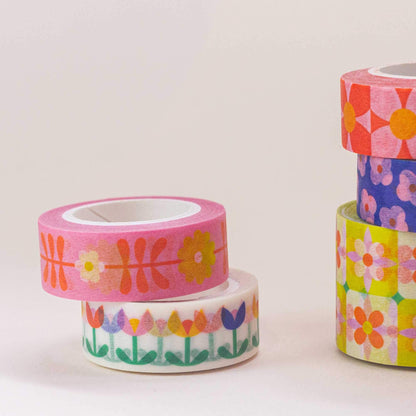Three rolls of colorful floral tape on a light background