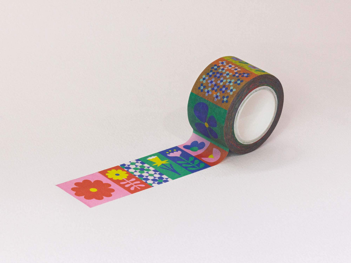 Roll of decorative tape with colorful floral patterns on a white background