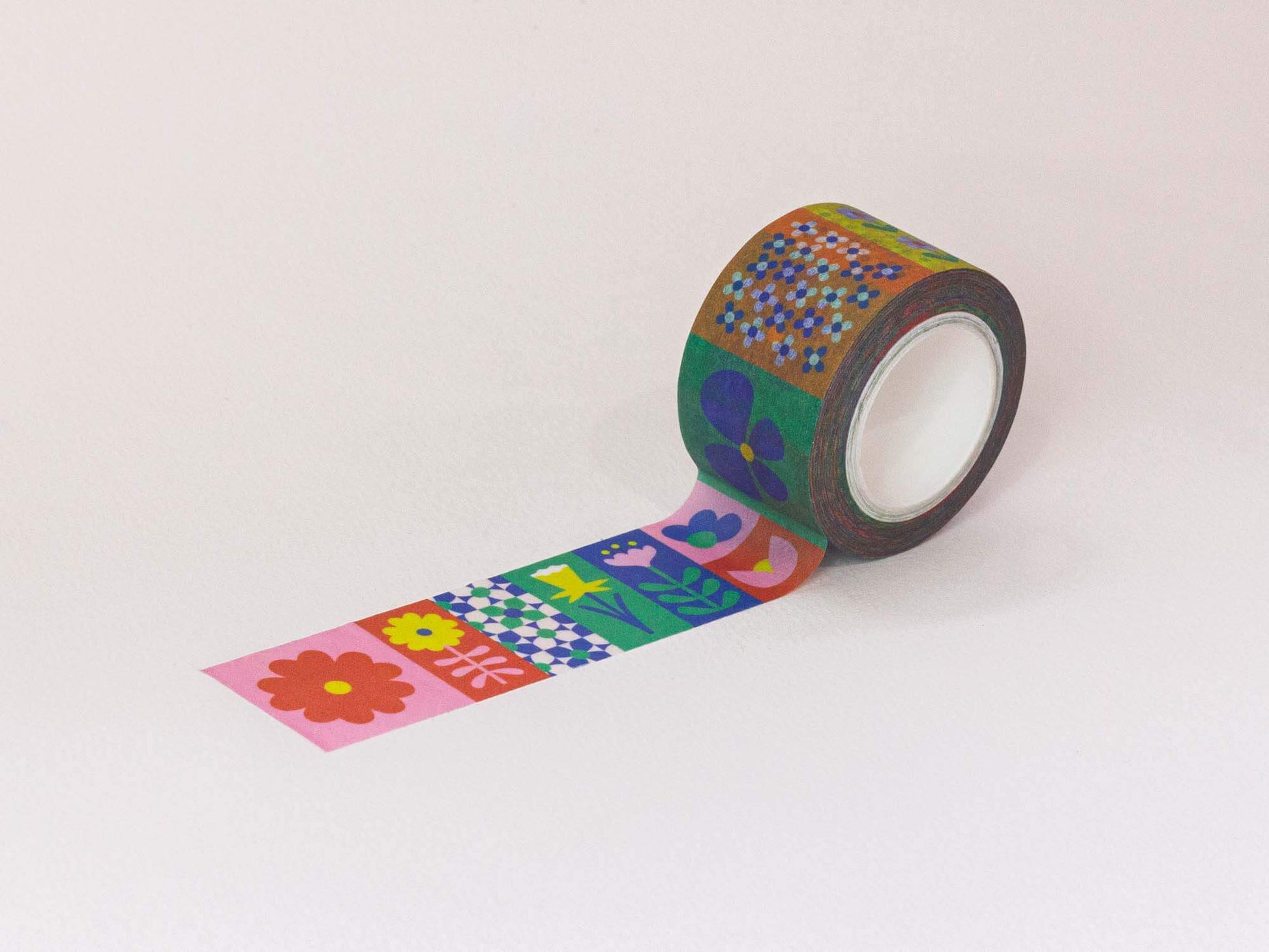 Roll of decorative tape with colorful floral patterns on a white background