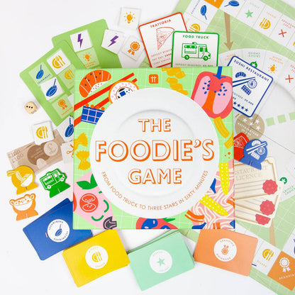 Colorful card game titled 'The Foodie's Game' with various cards on a white background