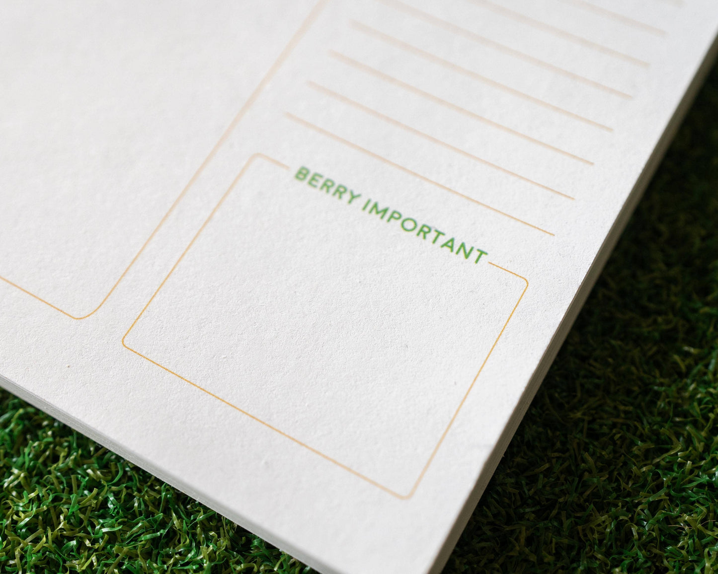Notebook with 'BERRY IMPORTANT' text on a grass background