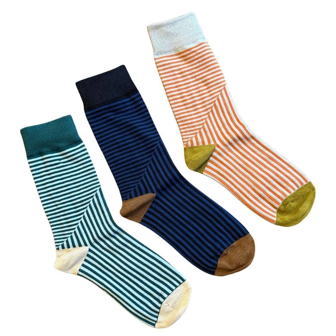 Three pairs of striped crew socks arranged diagonally on a white background. The left sock is teal and white striped with a dark teal cuff and cream toe.