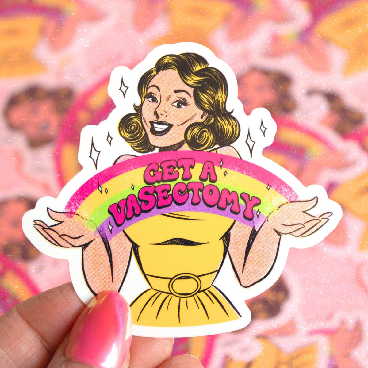 A die-cut sticker featuring a retro-style cartoon woman with wavy hair holding a rainbow banner that reads 'GET A VASECTOMY' in pink letters. The sticker is being held by a hand with pink nail polish against a blurred pink patterned background.