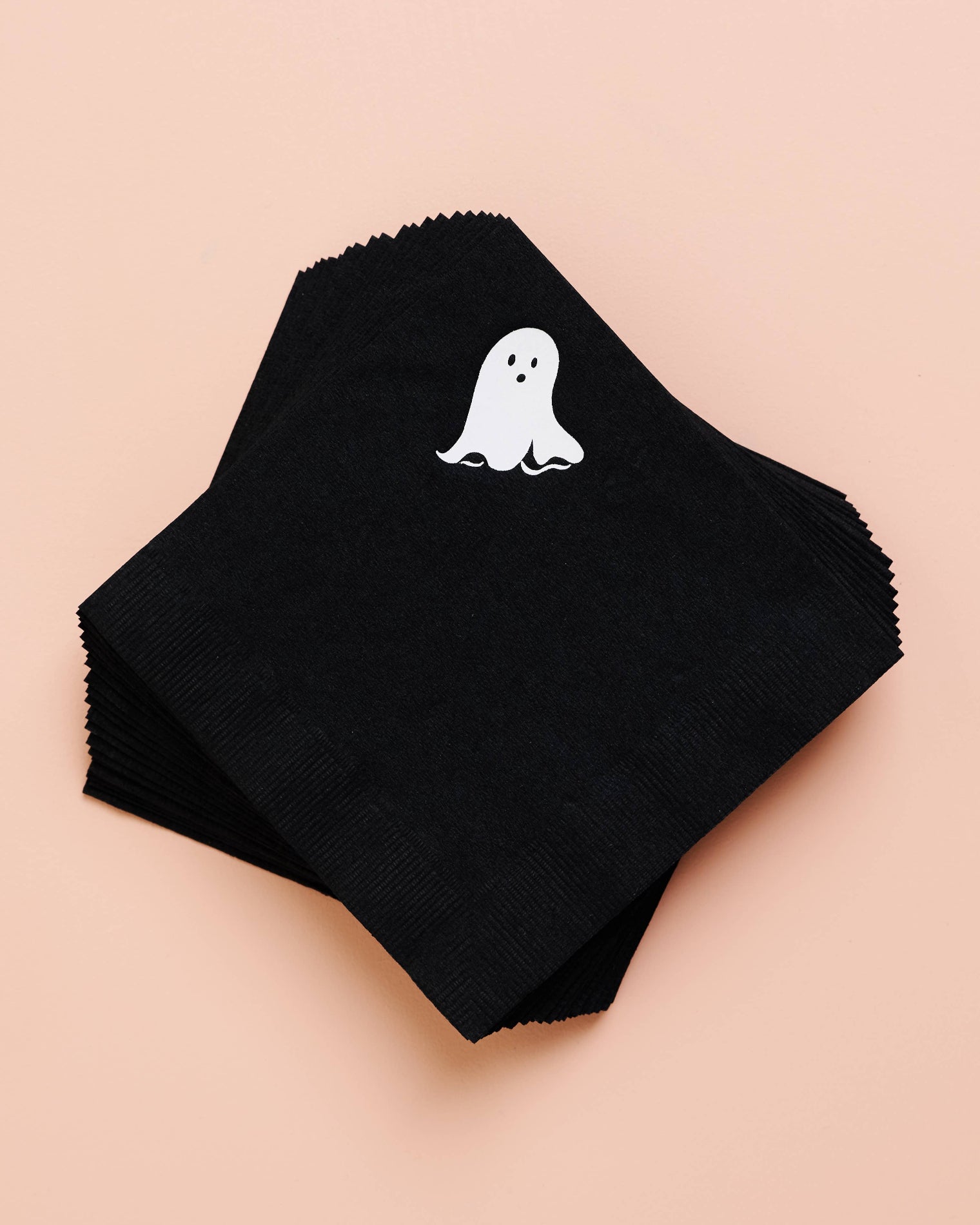 Black napkins with a white ghost design on a beige background, Ghost Beverage Napkin Set