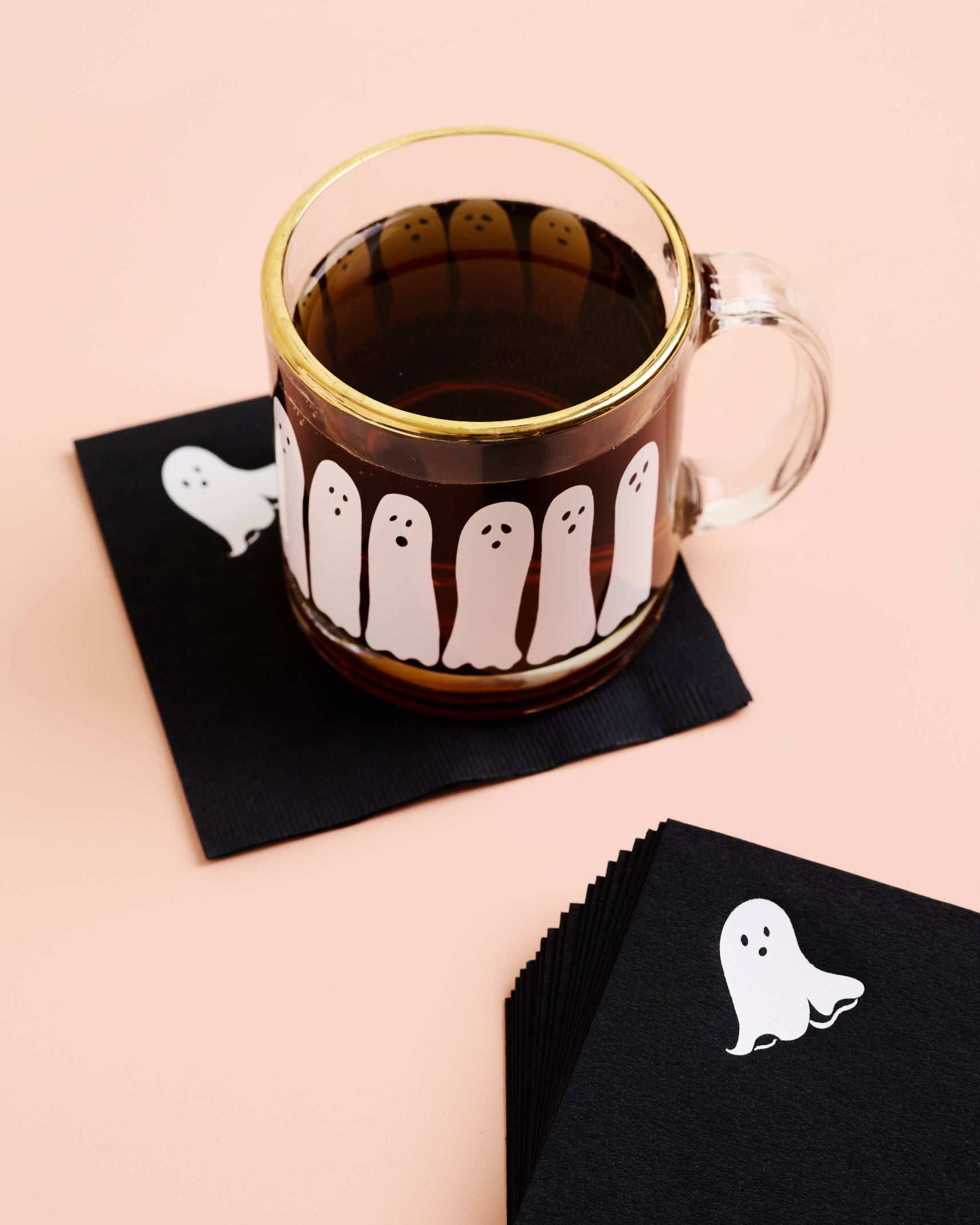 Clear mug with ghost design on a black napkin against a beige background, Ghost Beverage Napkin Set