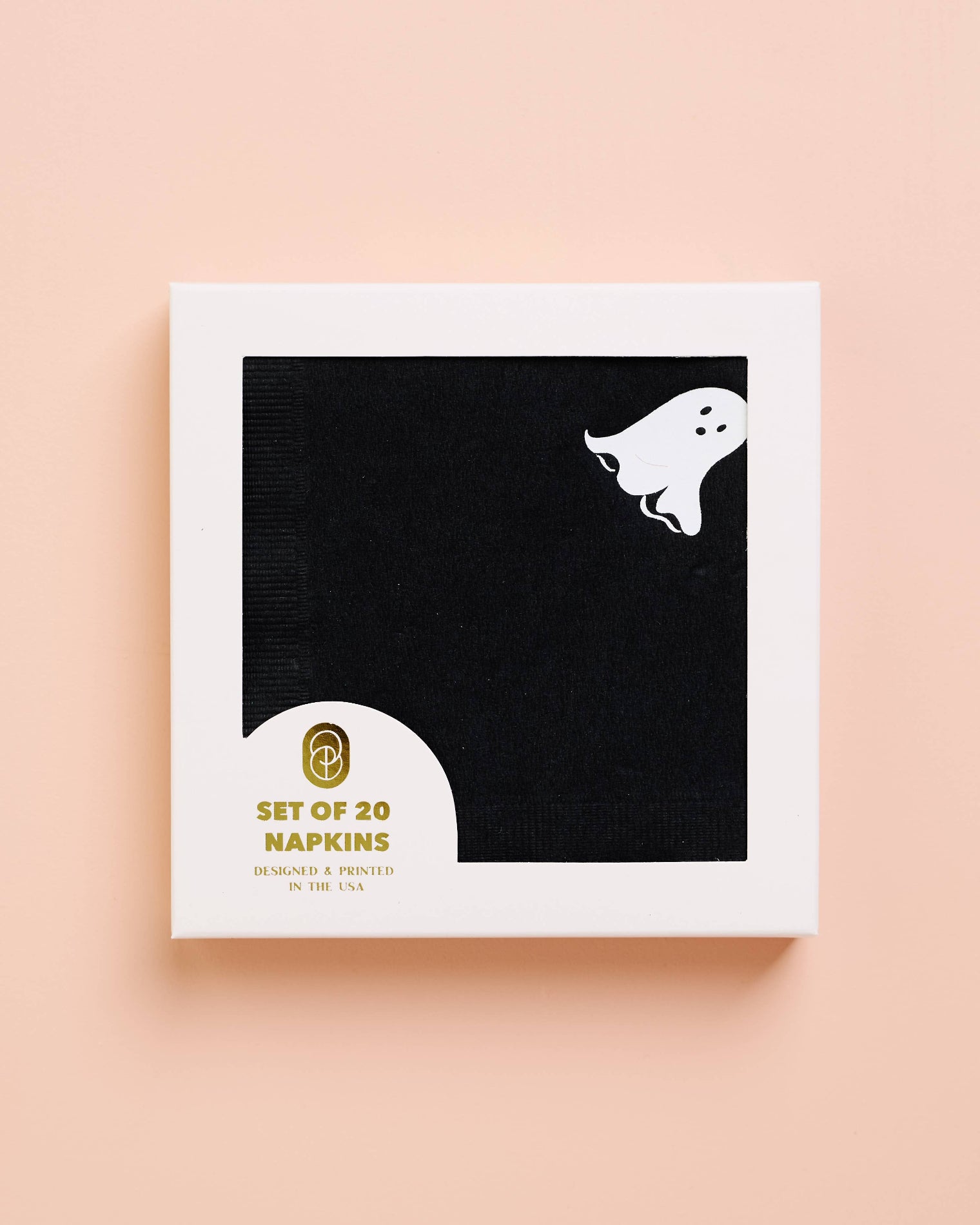 Packaging of black napkins with ghost design on a beige background