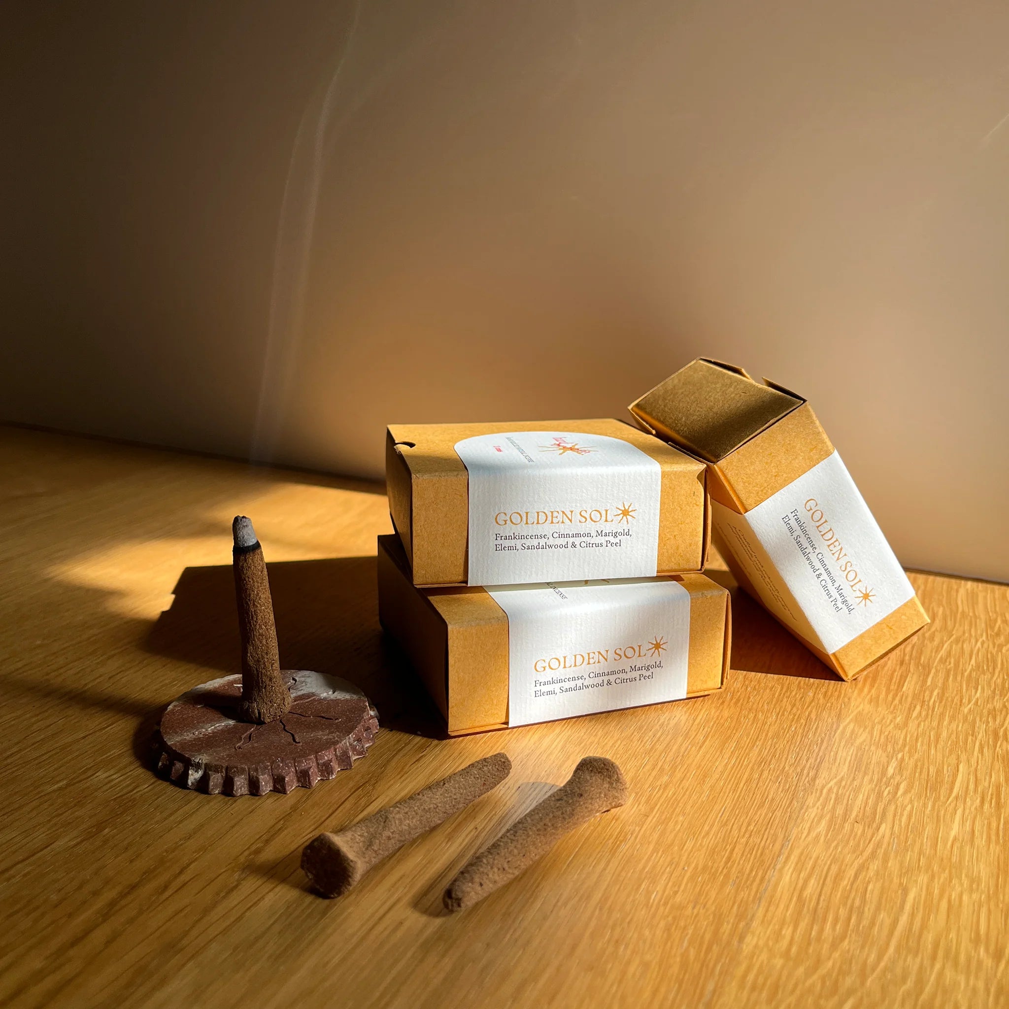 Dog treats and Golden Sol packaging on a wooden surface