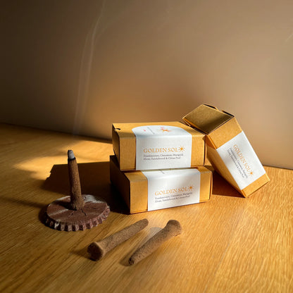 Dog treats and Golden Sol packaging on a wooden surface