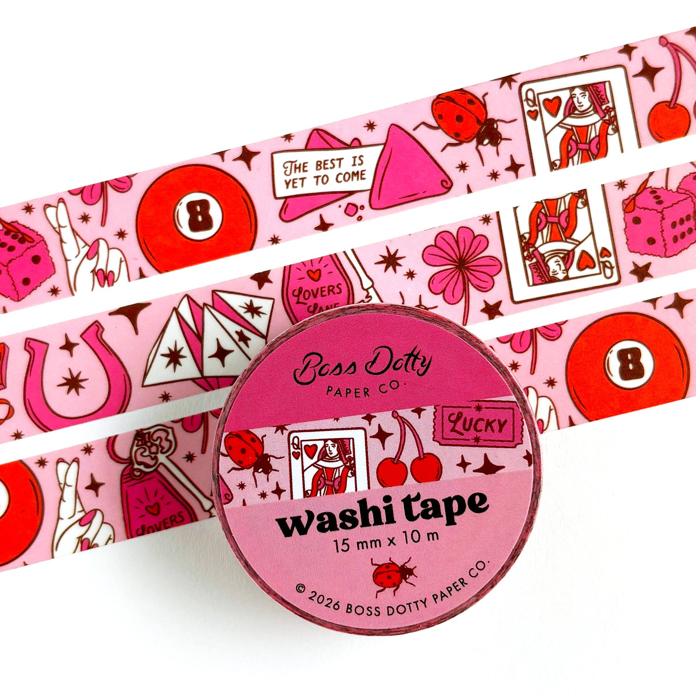 Pink washi tape with decorative designs and a circular container labeled 'Boss Dotty Paper Co.' on a white background.