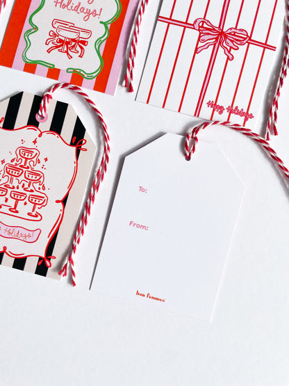 Holidays-themed gift tags and cards with red and white designs on a white background.