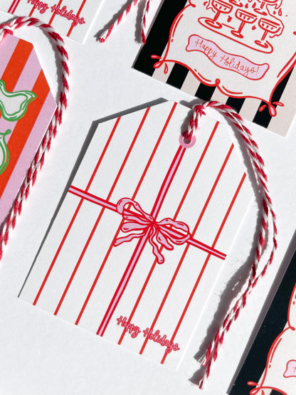 Set of Christmas gift tags with red ribbons and 'Happy Holidays!' text on a white background. Happy Holidays Gift Tag Set of 6