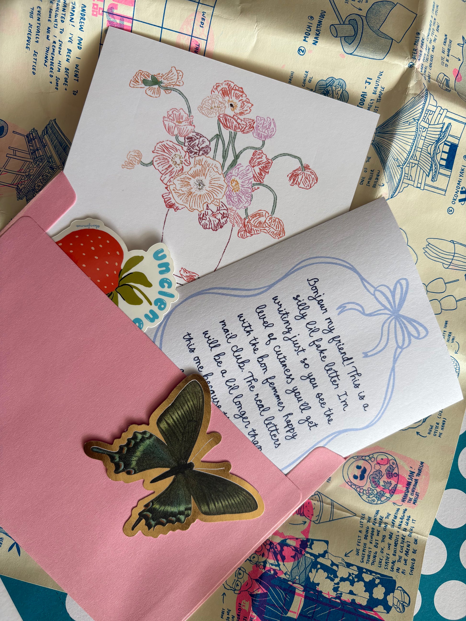 Floral card, letter, and butterfly ornament on a patterned surface, Happy Mail by Bon Femmes