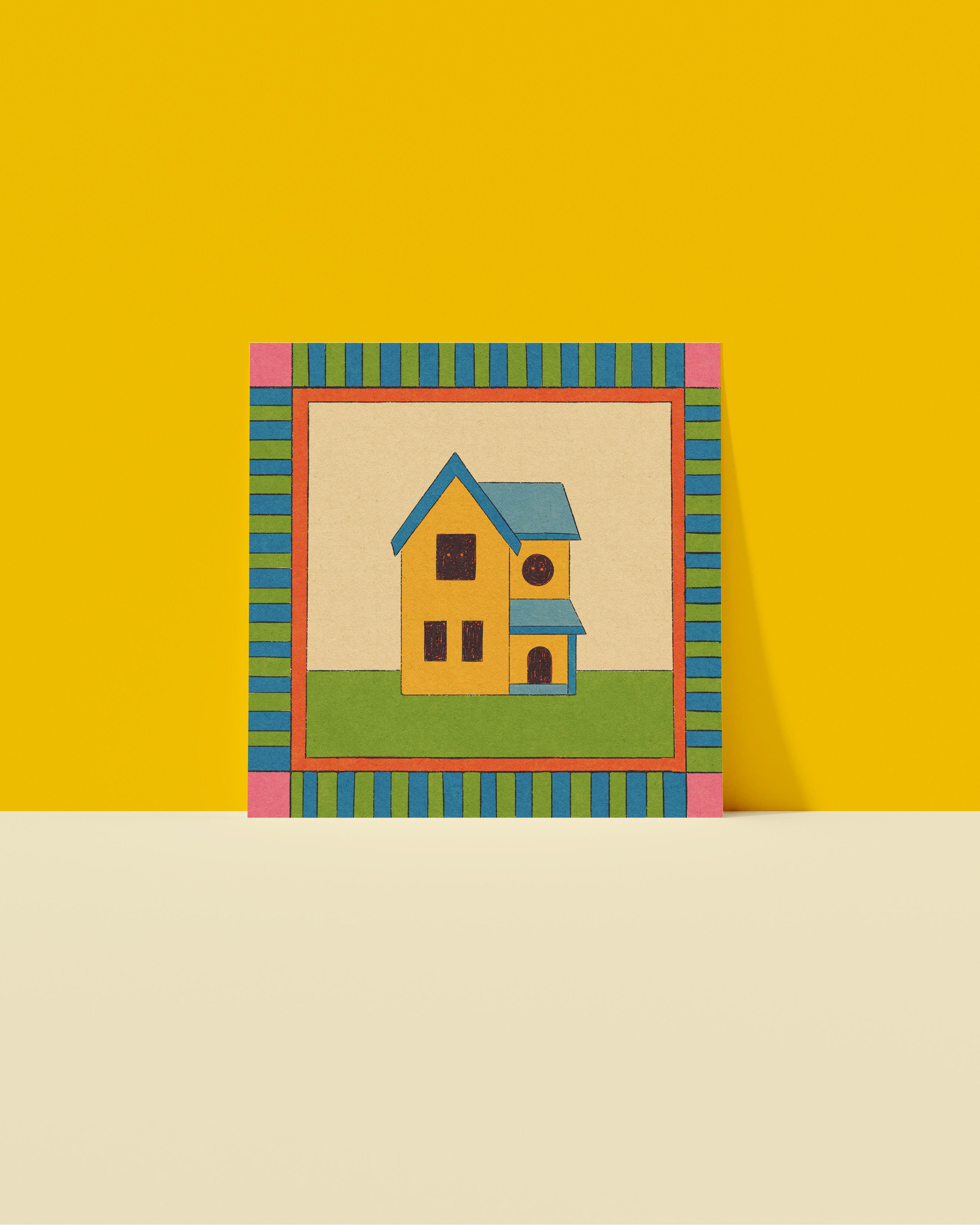Colorful frame with a small house inside on a yellow and beige background