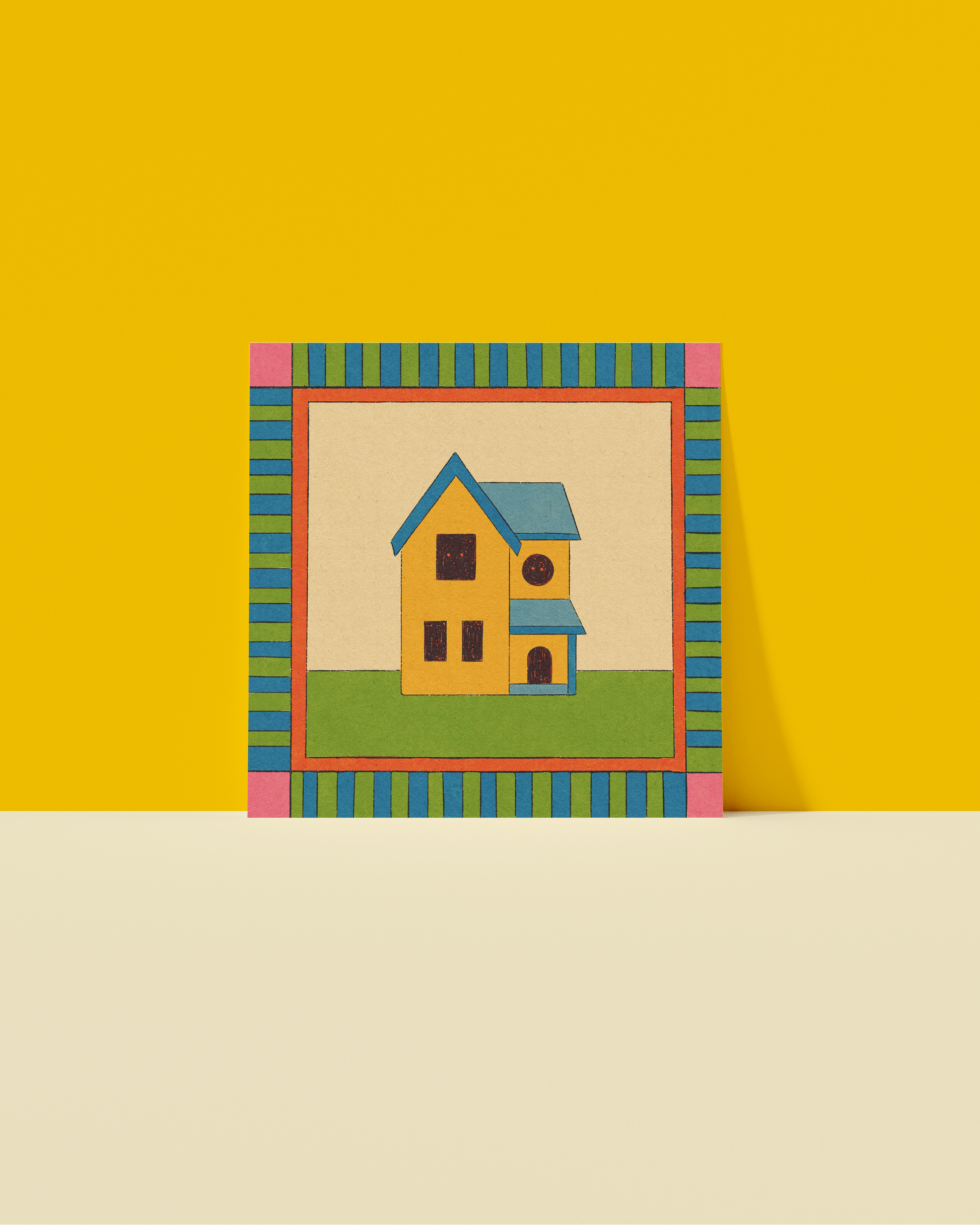 Colorful frame with a small house inside on a yellow and beige background