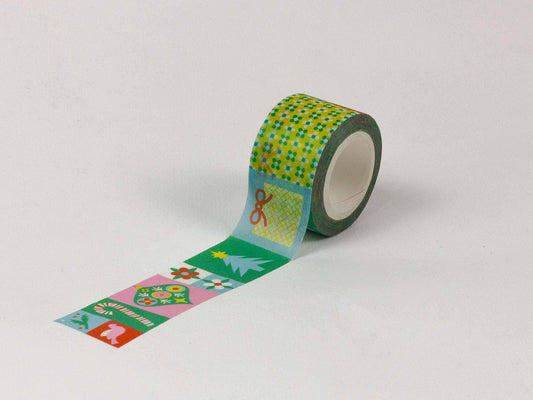 A roll of decorative washi tape with a green and yellow checkered pattern and a strip unrolled showing festive Christmas designs, photographed on a light gray background.
