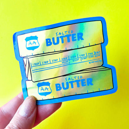 Holographic salt packaging with 'AA Salted Butter' text on a yellow background
