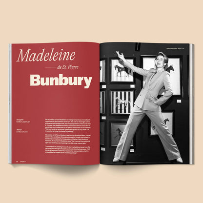 Open book with a red page featuring text and a black and white photo of a person in a stylish outfit.