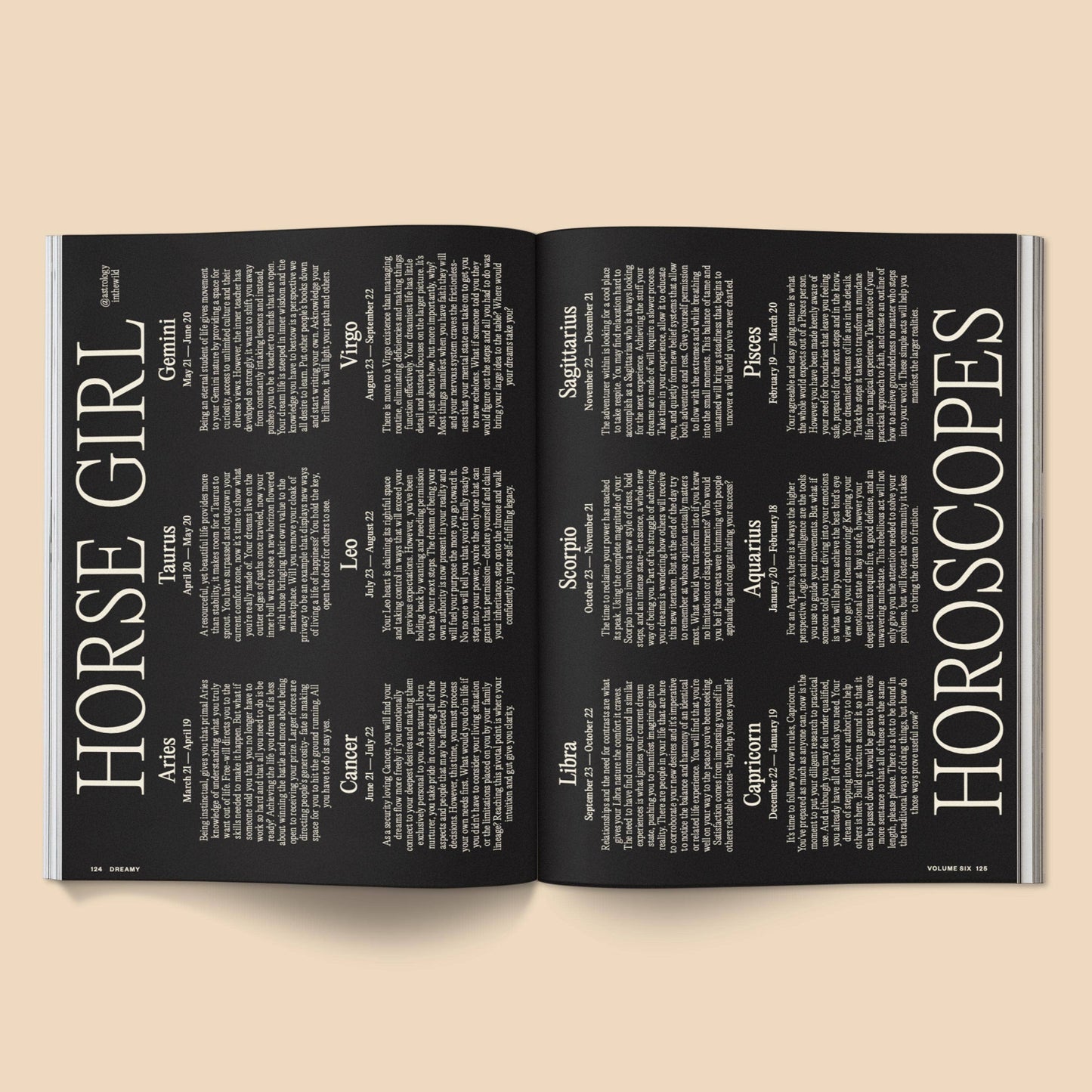 Open magazine with horoscope pages on a beige background