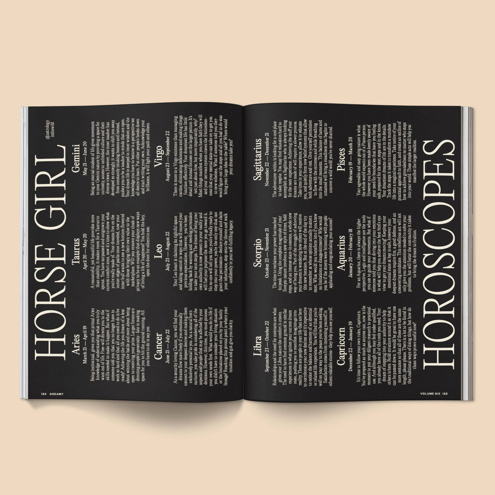Open magazine with horoscope pages on a beige background