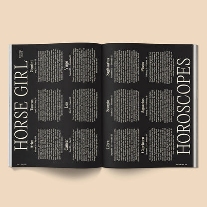 Open magazine with horoscope pages on a beige background