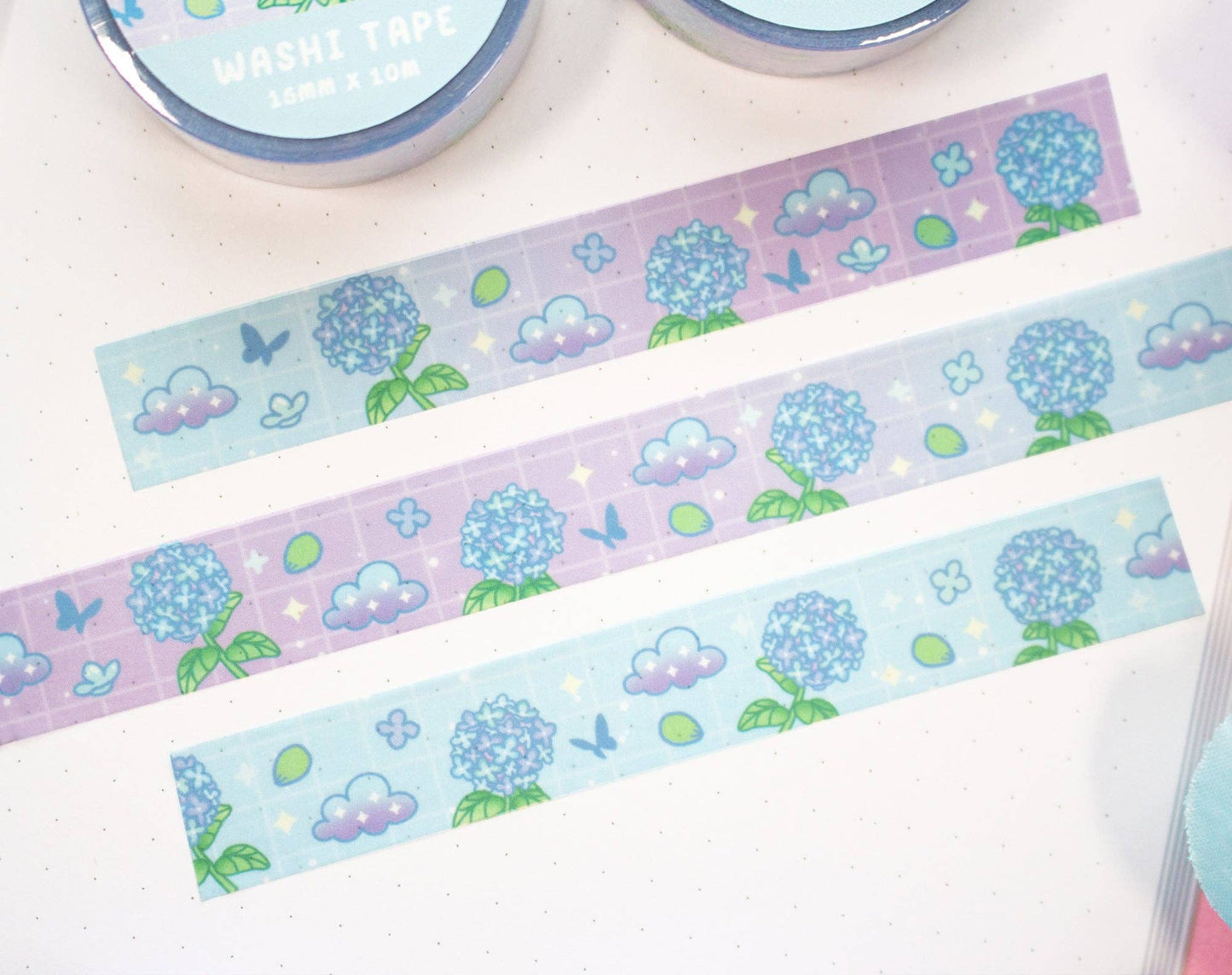 Decorative washi tape with floral and cloud designs on a white background