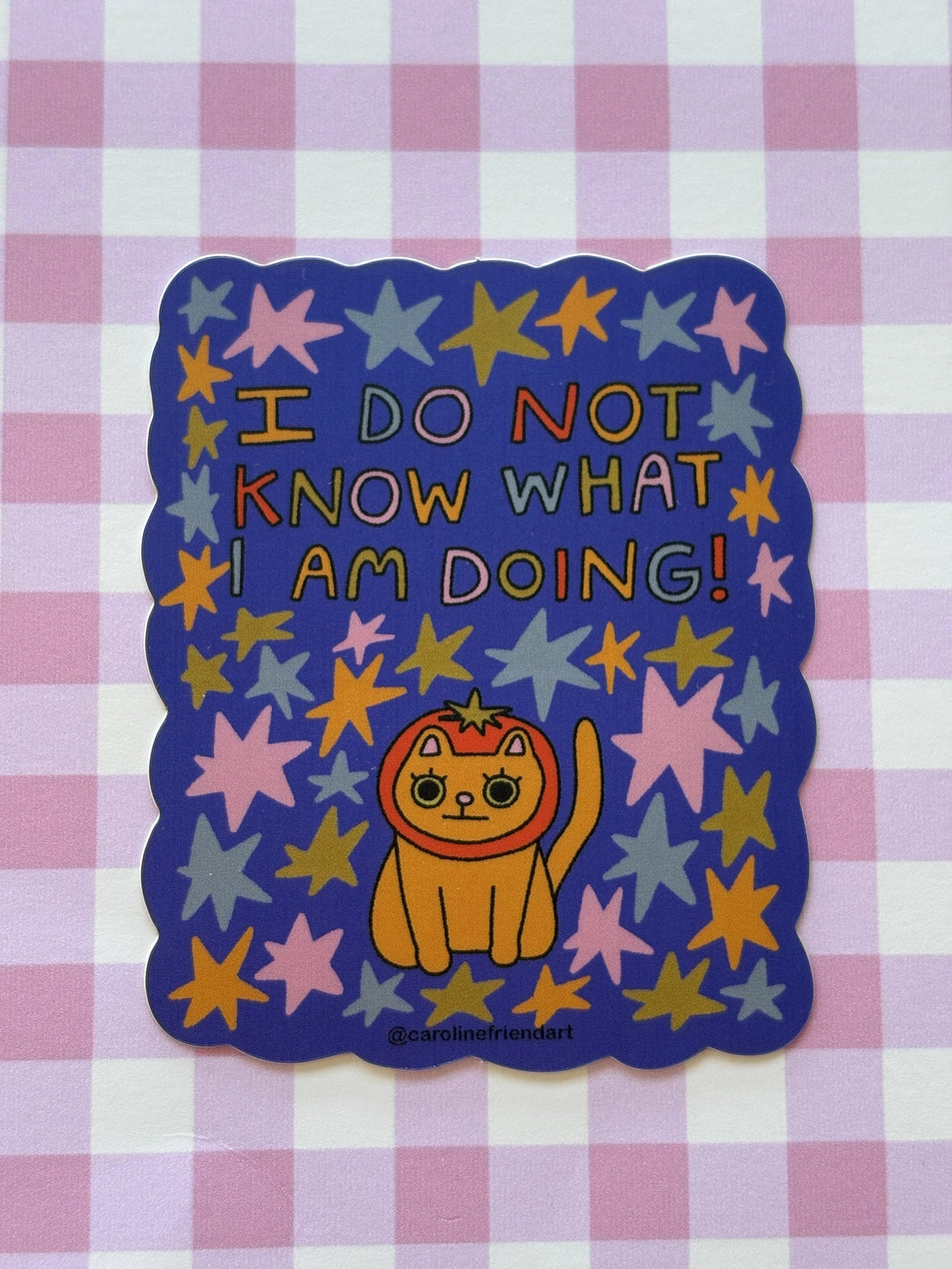 Cartoon cat with stars and text on a purple checkered background